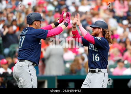 Seattle Mariners first Ryon Healy, left, and Mariners left fielder Ben Gamel celebrate scoring on a Jean Segura single in the eighth inning of a baseball game against the Detroit