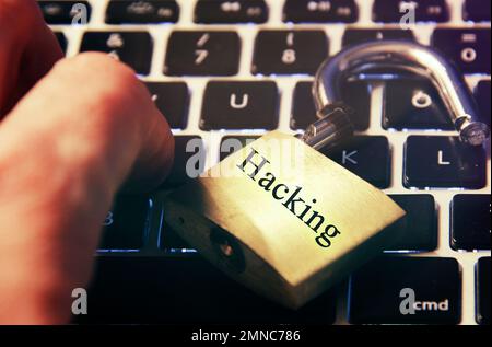 Hacked symbol on computer keyboard with open padlock Stock Photo