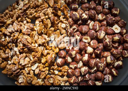 A Look at life in New Zealand: Freshly dry-roasted walnuts and hazelnuts. (Walnut Tree : Juglans regia : Hazelnuts  Corylus avellana). Stock Photo