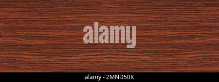 Rosewood texture. Texture of dark mahogany with an intense pattern, natural rosewood veneer for the production of furniture or yacht decoration Stock Photo