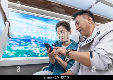 Happy elderly couple take the subway Stock Photo