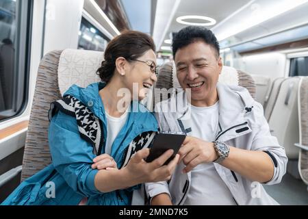 Happy elderly couple take the subway Stock Photo
