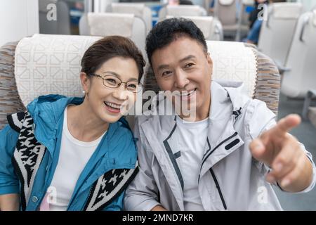Happy elderly couple take the subway Stock Photo