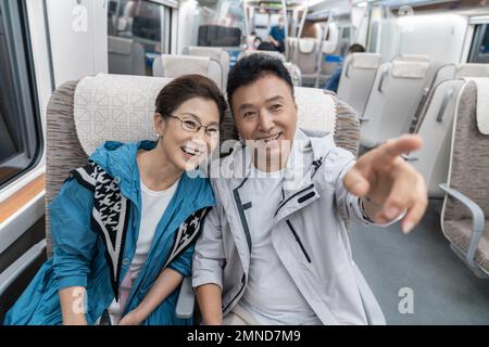 Happy elderly couple take the subway Stock Photo