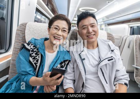 Happy elderly couple take the subway Stock Photo