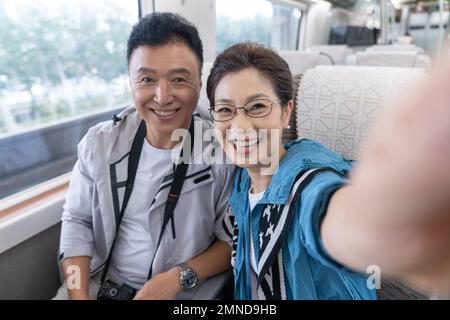 Happy elderly couple take the subway Stock Photo