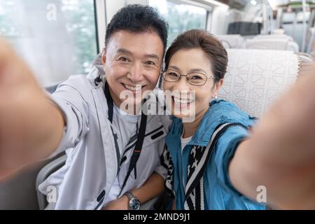 Happy elderly couple take the subway Stock Photo