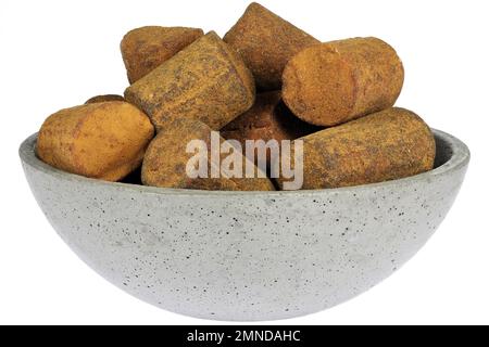 Dutch cinnamon candy sticks in a concrete bowl isolated on white background Stock Photo