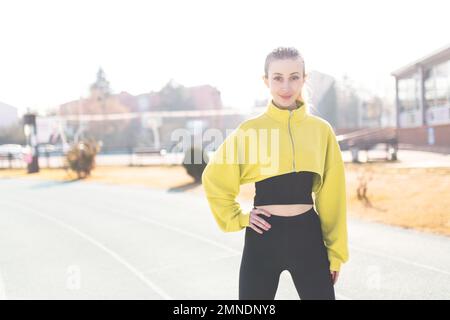 Beautiful smiling confident woman athlete portrait during winter Stock Photo