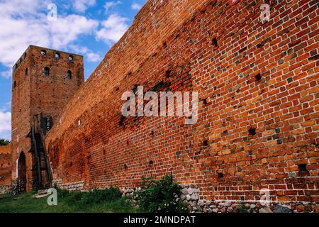Tower and wall made of red brick old castle of dukes of Mazovia in Czersk, Poland Stock Photo
