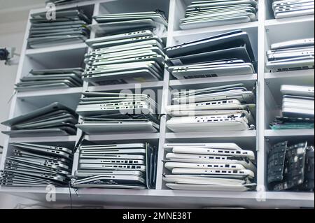 Stack of old, broken and obsolete laptop computer for repair and recycle Stock Photo