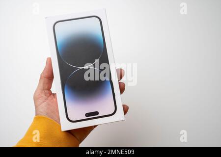 A man holds the latest iPhone 14 Pro Max in Space Black. Apple's latest phone is equipped with three cameras. W Stock Photo