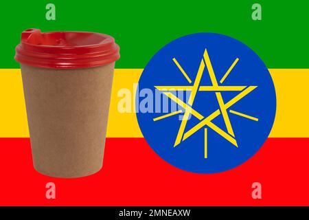 Disposable paper cup of coffee on the background of the national flag of Ethiopia. The largest exporter of coffee in the world. Ethiopian coffee Stock Photo