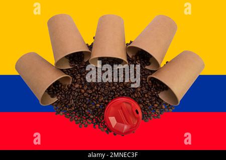 Five overturned disposable paper cups filled with roasted coffee beans against the background of the Colombian flag (close-up) Stock Photo
