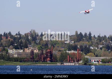 A Kenmore Air Seaplane Flies Over Downtown Seattle And The Bell Harbor ...