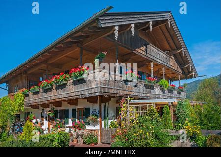 Farmhouse converted into a residence with floral decorations in Wegscheid near Lenggries, Bavaria, Germany Stock Photo