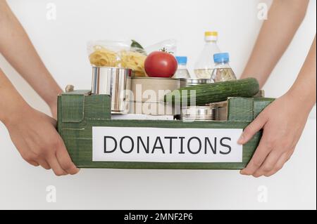 volunteers holding box filled with food donation. Resolution and high quality beautiful photo Stock Photo