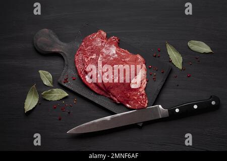 https://l450v.alamy.com/450v/2mnf6af/fresh-uncooked-meat-wooden-board-with-knife-resolution-and-high-quality-beautiful-photo-2mnf6af.jpg