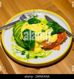 Poached egg boiled sandwich with salmon and avocado. Healthy breakfast concept Stock Photo