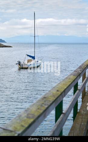 Salish Sea Sailboat Sunshine Coast BC. A sailboat at anchor off the Sunshine Coast BC. Stock Photo