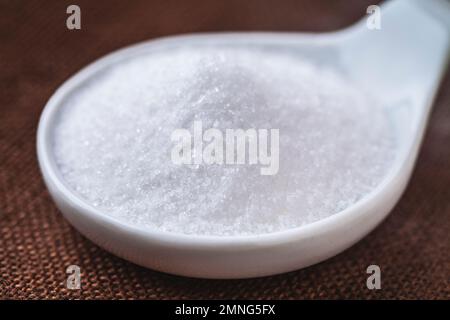 Refined white sugar in a bowl on background Stock Photo