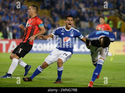 David Silva of Colombia's Millonarios, left, heads to score his side's  opening goal against Brazil's Atletico Mineiro during a Copa Libertadores  soccer match at El Campin stadium in Bogota, Colombia, Wednesday, March