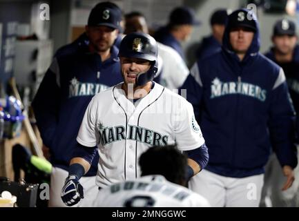 Seattle Mariners' Tom Murphy reacts in the dugout after he hit a