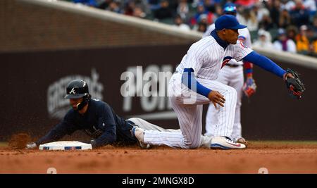 Chicago Cubs' Dansby Swanson slides safely into third base during
