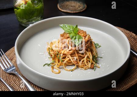 Portion of homemade spaghetti bolognese served in ceramic plate. Stock Photo