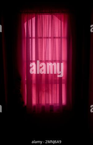 Daylight Streaming through Sheer Red Window Curtains Stock Photo