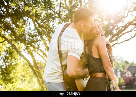 Romantic couple playing guitar and dancing Stock Photo