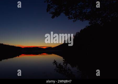 Scenic sunset at a tranquil Swedish lake on the high coast trail in summertime Stock Photo