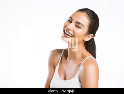 Portrait of smiling young woman looking at camera Stock Photo