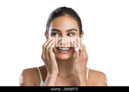 Portrait of young woman doing face massage Stock Photo