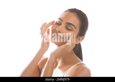 Portrait of smiling young woman doing face massage Stock Photo