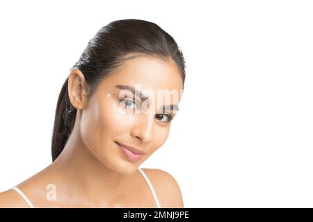 Portrait of smiling young woman looking at camera Stock Photo