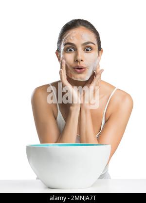 Portrait of young woman enjoying washing face Stock Photo