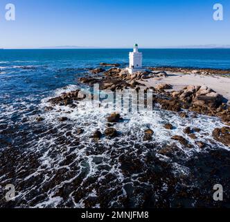 South Africa, Western Cape, St. Helena Bay, White lighthouse on coast of Atlantic Ocean Stock Photo