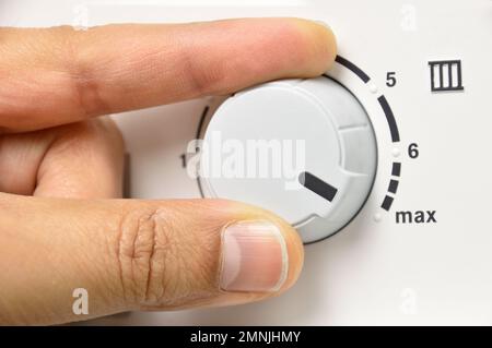 hand rotate temperature adjuster of water heater.High temp Stock Photo