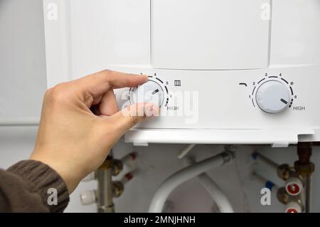 hand rotate temperature adjuster of water heater.High temp Stock Photo