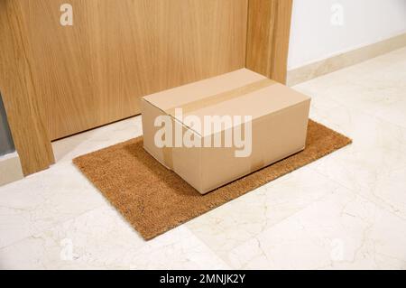 carton box on the floor of doorway home Stock Photo