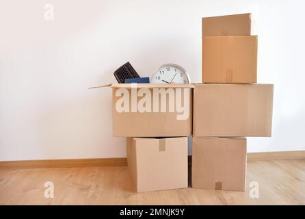 Office accessories in a cardboard box at office. Stock Photo