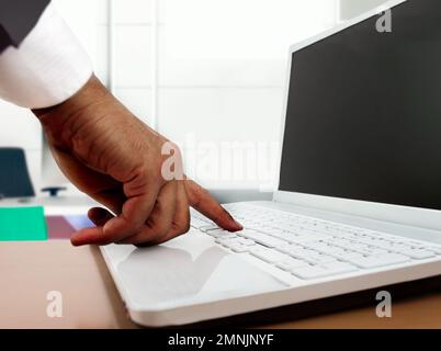 Closeup of businessman hand typing on computer keyboard at office Stock Photo