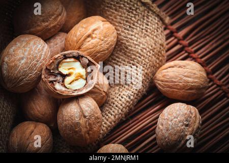 handful of nuts on a sheet of jute with broken shell Stock Photo - Alamy