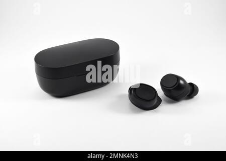 True Wireless Earphone bluetooth voice control with charger isolated on white background. Stock Photo