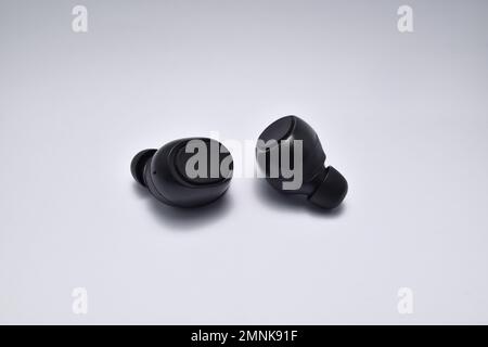 True Wireless Earphone bluetooth voice control isolated on white background. Stock Photo