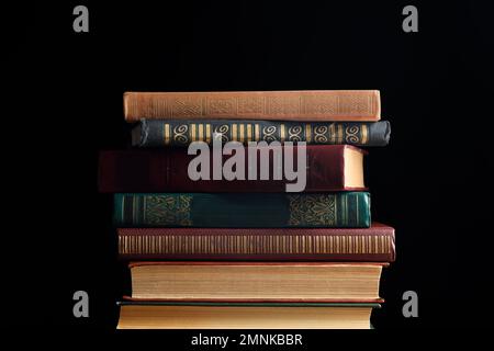 Collection of different books on dark background Stock Photo