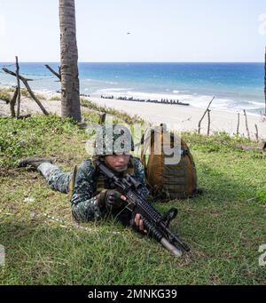 A Philippine Marine posts notional security during KAMANDAG 6, in Claveria, Philippines, Oct. 3, 2022. The two forces participated in a bilateral amphibious assault focused on increasing interoperability and shared understanding of tactics. KAMANDAG is an annual, bilateral exercise between the Armed Forces of the Philippines and U.S. military designed to strengthen interoperability, capabilities, trust and cooperation built over decades of shared experiences. Stock Photo