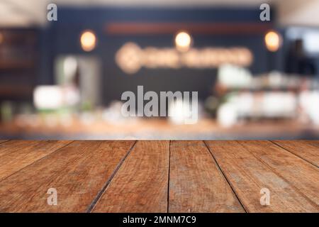 Perspective brown wood on blur cafe with light bulb background, stock photo Stock Photo