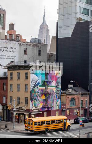 Gandhi and Mother Teresa mural on Chelsea Market building with the Empire State Building in the background, New York, USA. Stock Photo